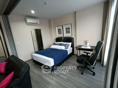 Modern bedroom with stylish decor and workspace, featuring a comfortable bed and sleek desk.