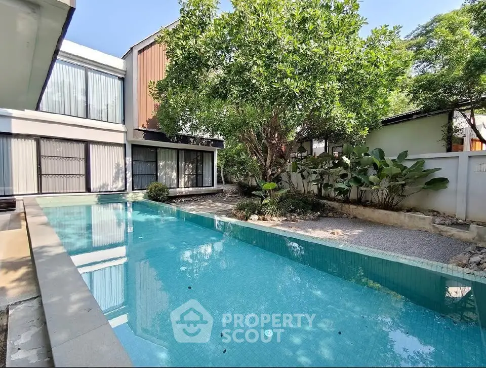 Modern home with private pool and lush garden, perfect for luxury living.