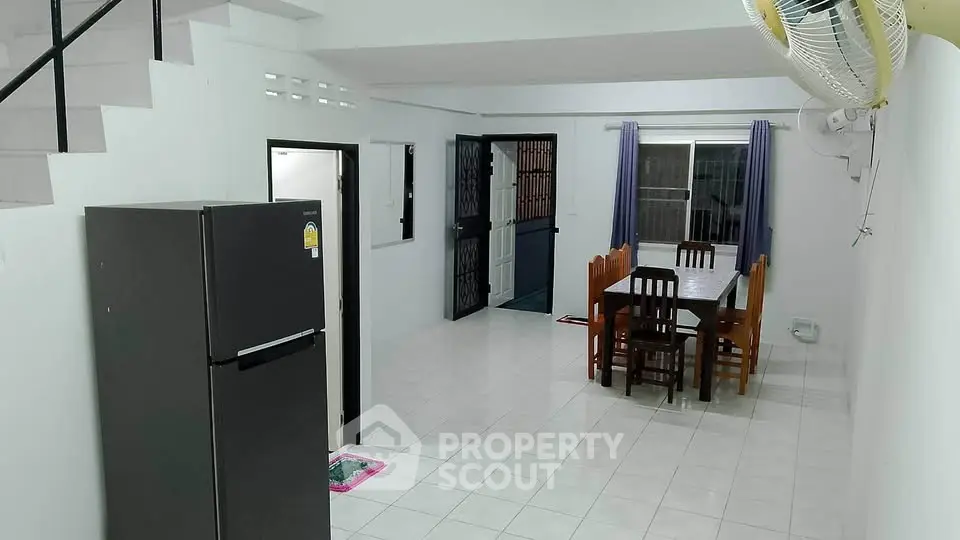 Spacious open-plan living and dining area with modern furnishings and natural light.