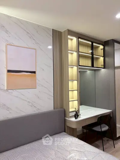 Modern bedroom with stylish decor and built-in vanity in a cozy apartment.
