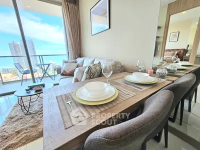 Modern living room with dining area and stunning city view from balcony