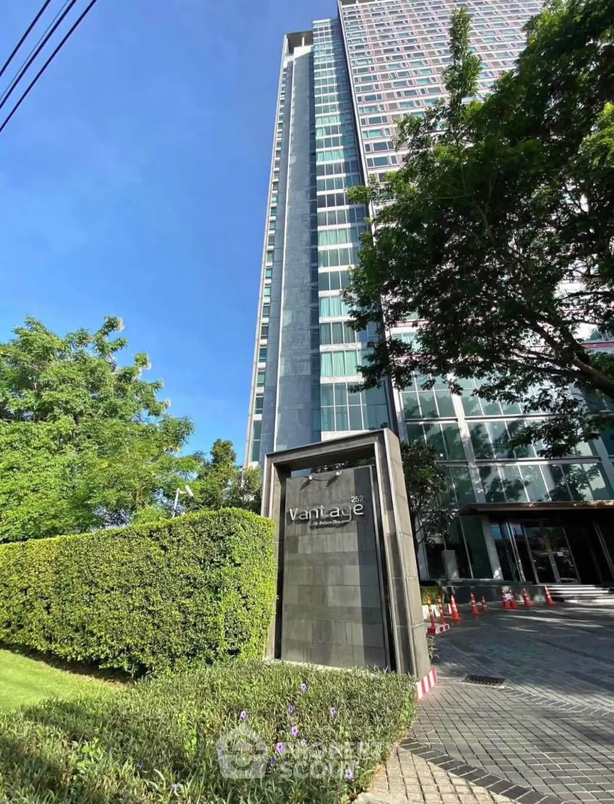 Stunning high-rise building with modern architecture and lush greenery, perfect for urban living.