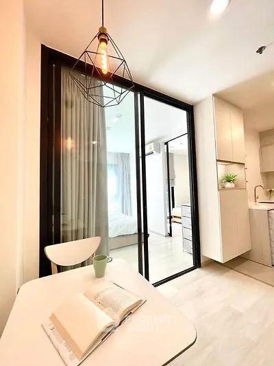 Modern apartment interior with open kitchen and cozy dining area