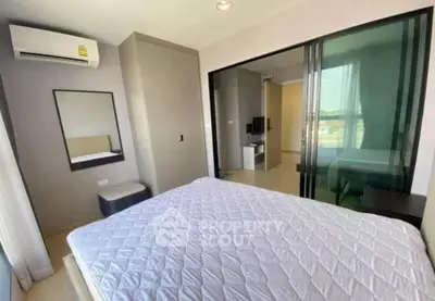 Modern bedroom with sliding glass doors and air conditioning in a stylish apartment.