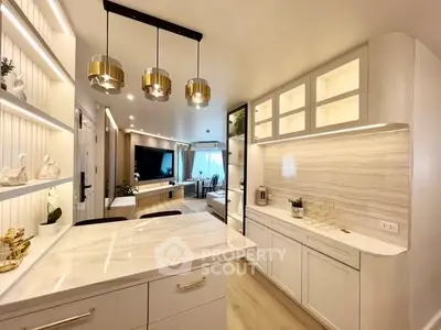 Modern open kitchen with elegant lighting and sleek cabinetry