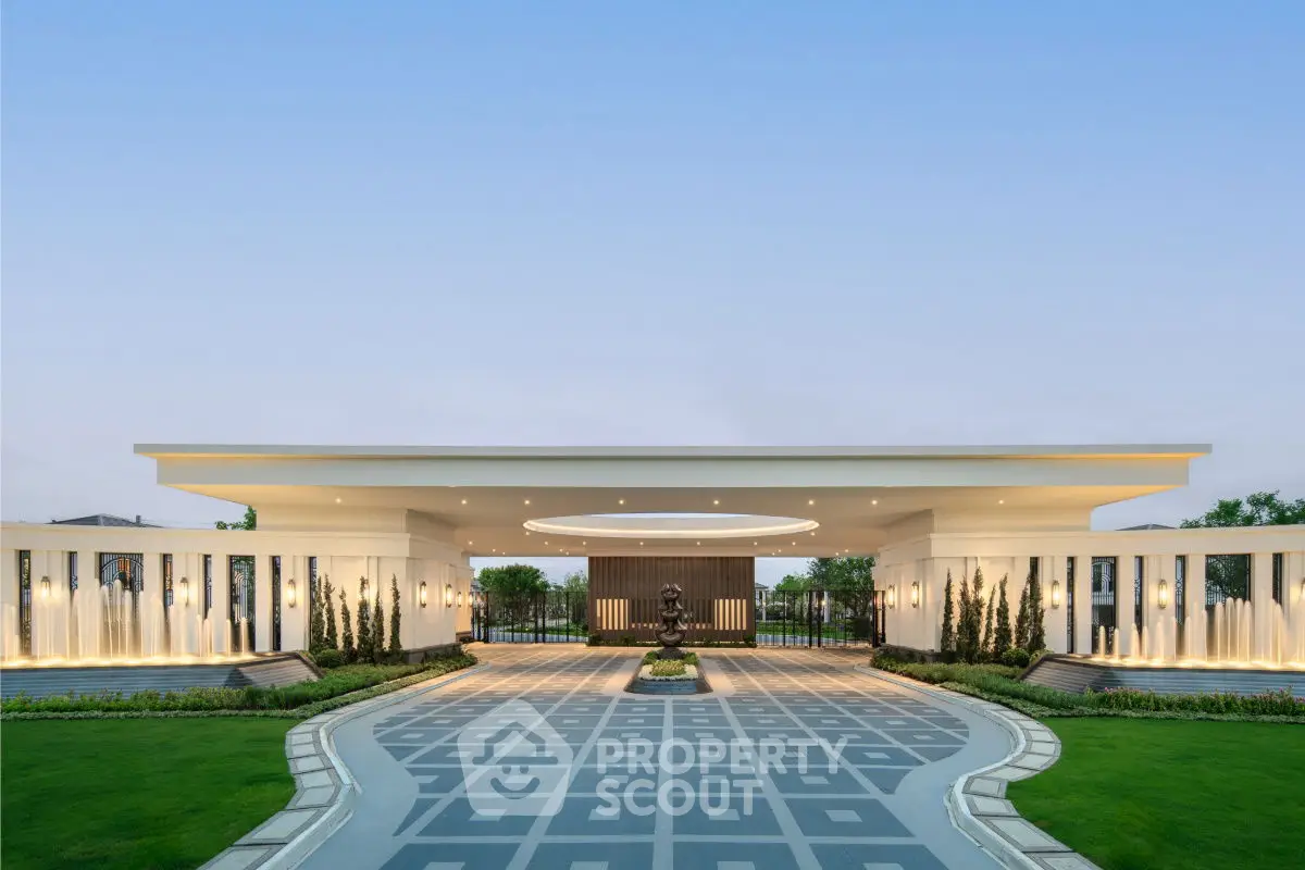 Luxurious modern building entrance with elegant design and landscaped surroundings.