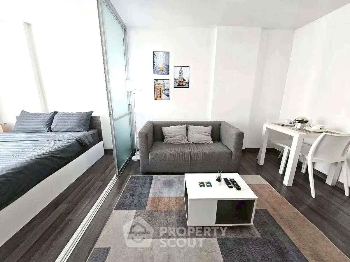 Modern studio apartment with stylish living area and cozy bedroom