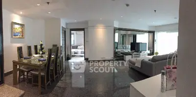 Spacious open-plan living and dining area with modern decor and ample natural light.