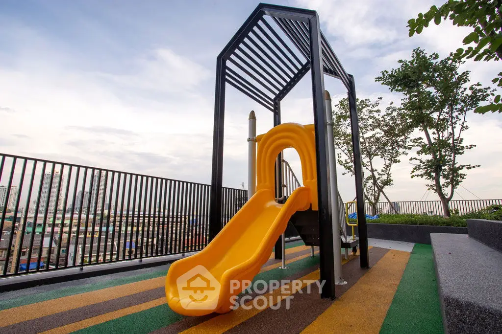Modern rooftop playground with slide and city view, perfect for family-friendly living.