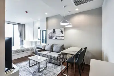 Modern living room with cozy sofa, stylish dining area, and elegant decor in a bright apartment.
