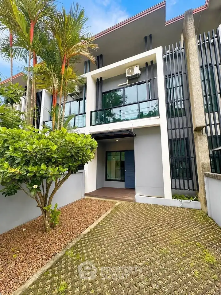 Modern townhouse exterior with lush greenery and sleek design
