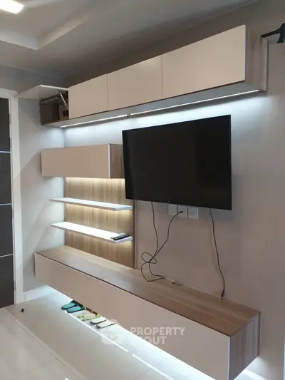 Modern living room with sleek TV unit and ambient lighting