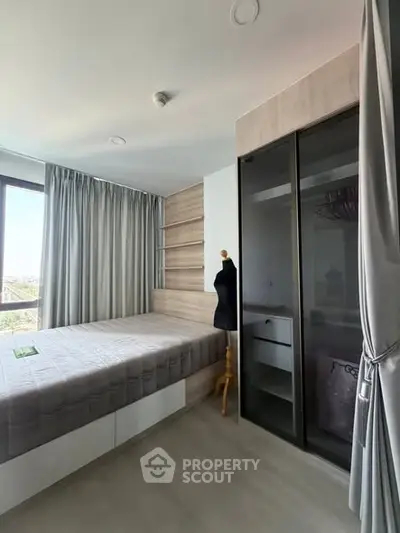 Modern bedroom with large window and sleek wardrobe design