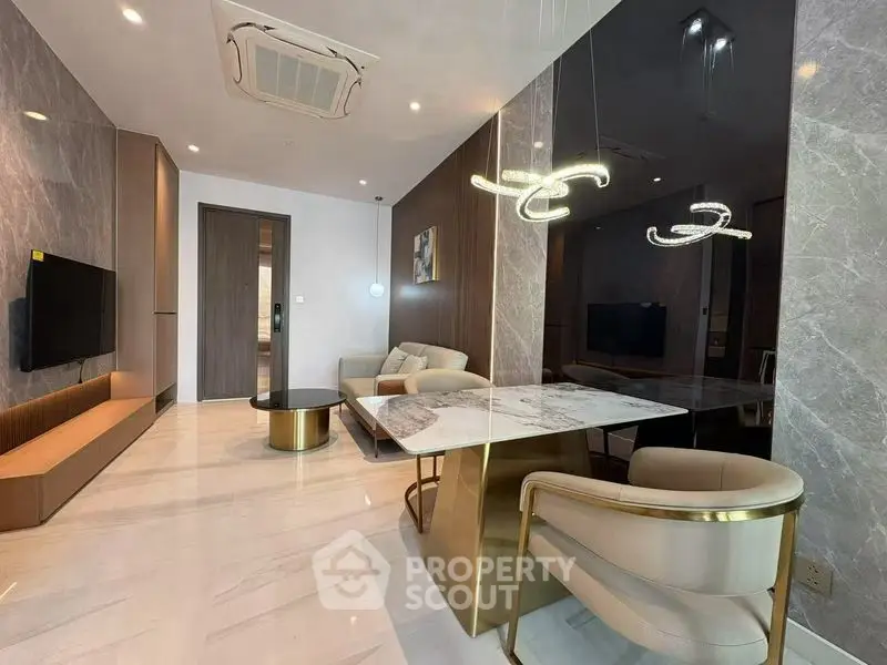 Luxurious modern living room with elegant marble accents and stylish lighting fixtures.