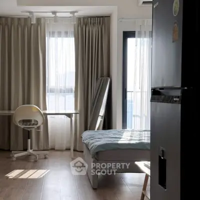 Bright modern bedroom with large windows and sleek furniture, perfect for urban living.