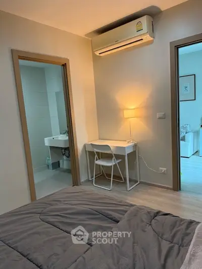 Cozy bedroom with study nook and ensuite bathroom in modern apartment