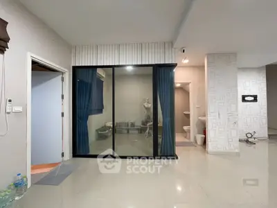 Spacious modern interior with sliding glass doors and tiled flooring