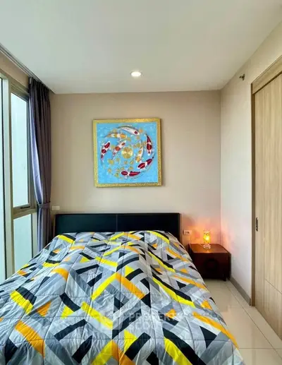 Modern bedroom with stylish decor and large window for natural light