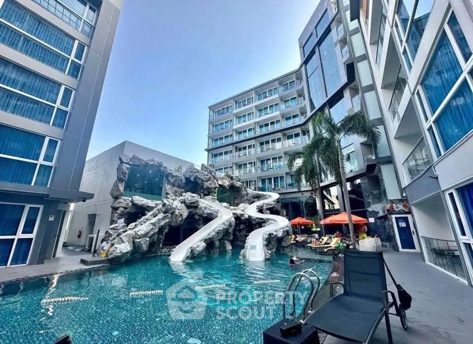 Luxurious apartment complex with stunning pool and water slides, perfect for relaxation and entertainment.