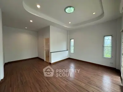 Spacious modern living room with wooden flooring and recessed lighting