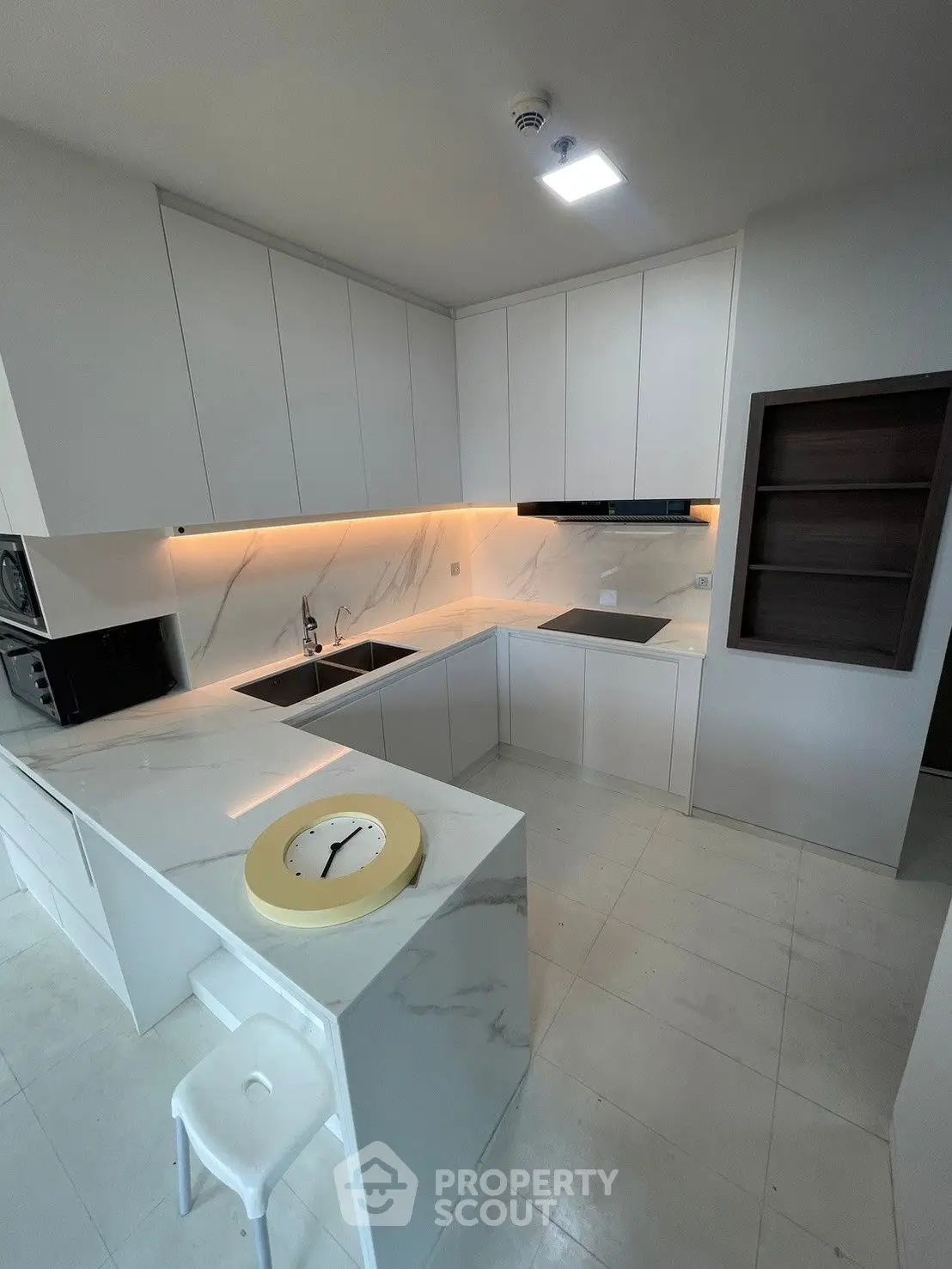 Modern kitchen with sleek white cabinets and marble countertops