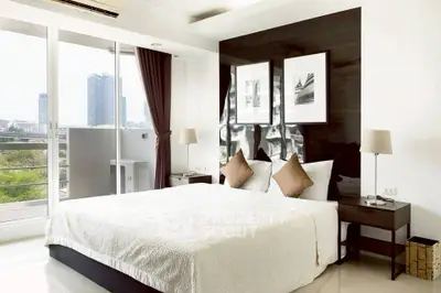 Modern bedroom with city view and elegant decor in high-rise apartment