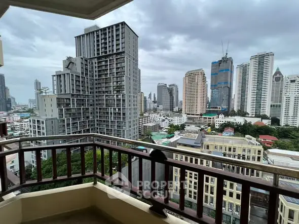 Stunning cityscape view from a high-rise balcony in a bustling urban area.