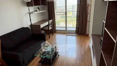 Modern living room with wooden flooring, glass coffee table, and balcony view.