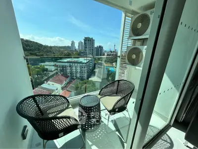 Chic balcony with modern seating and stunning city view, perfect for relaxation and enjoying urban living.