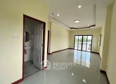 Spacious living room with balcony access and natural light