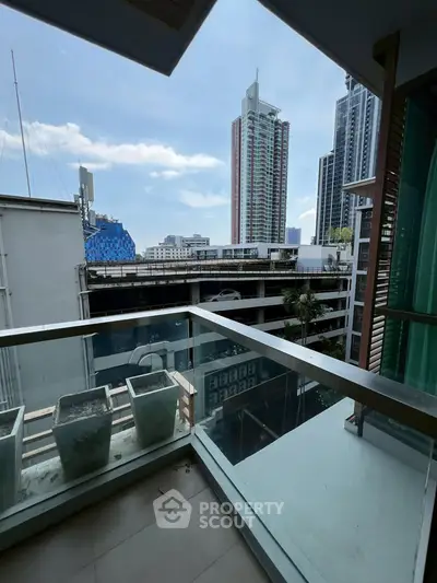 Modern urban balcony with city skyline view, perfect for relaxation and enjoying the vibrant city life.