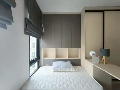 Modern minimalist bedroom with sleek storage and natural light