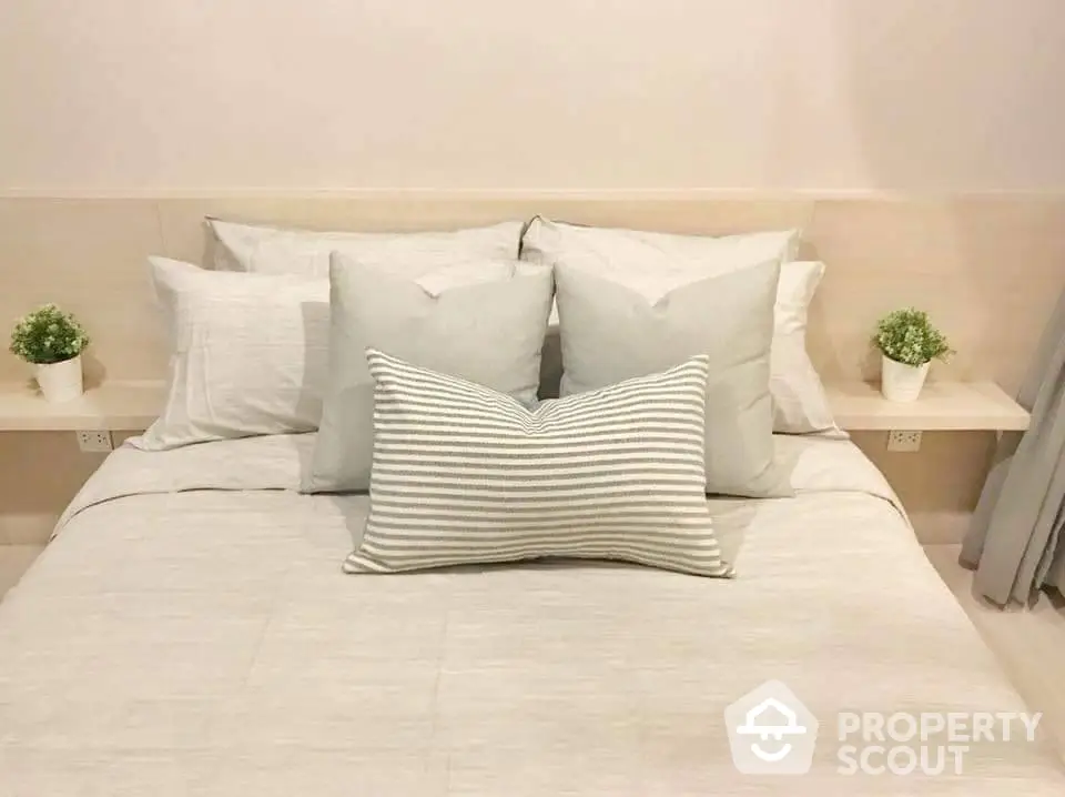 Cozy bedroom with neutral tones and decorative pillows