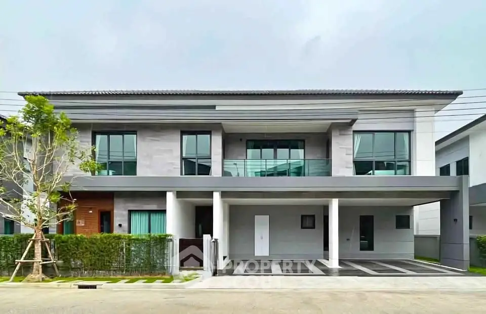 Modern two-story house with sleek design and spacious driveway