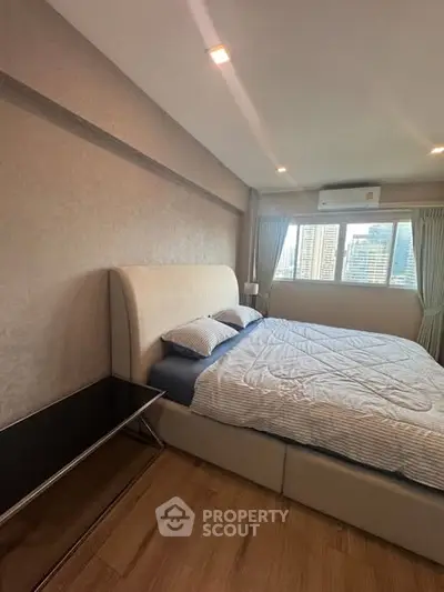 Luxurious bedroom with city view, featuring a plush bed and modern decor, perfect for urban living.