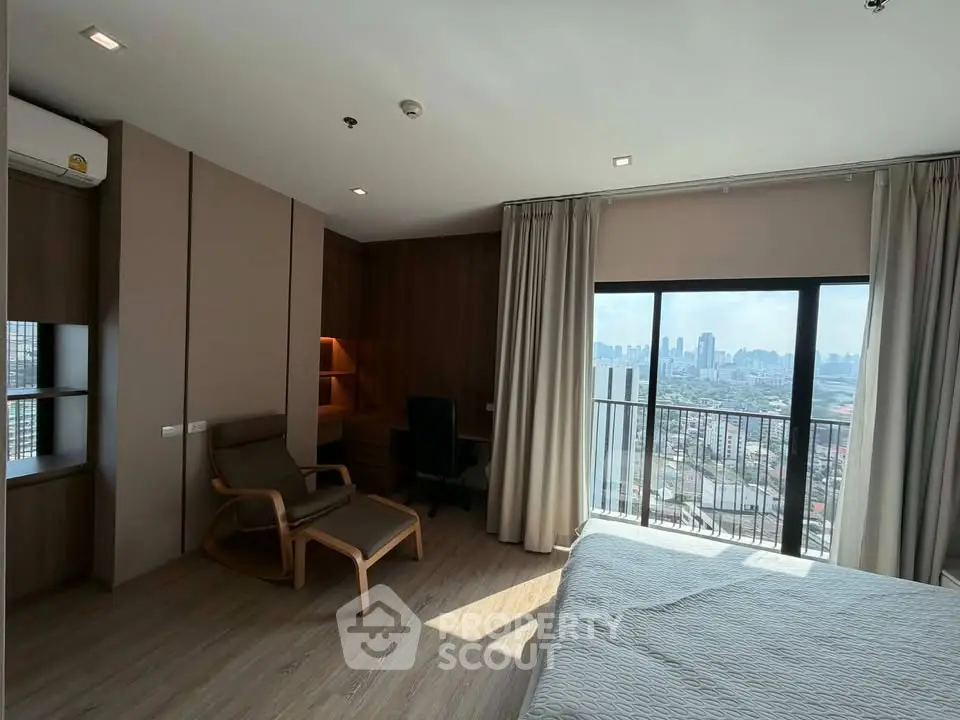 Spacious bedroom with city view and modern furnishings