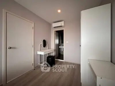 Modern bedroom with sleek furniture and air conditioning unit