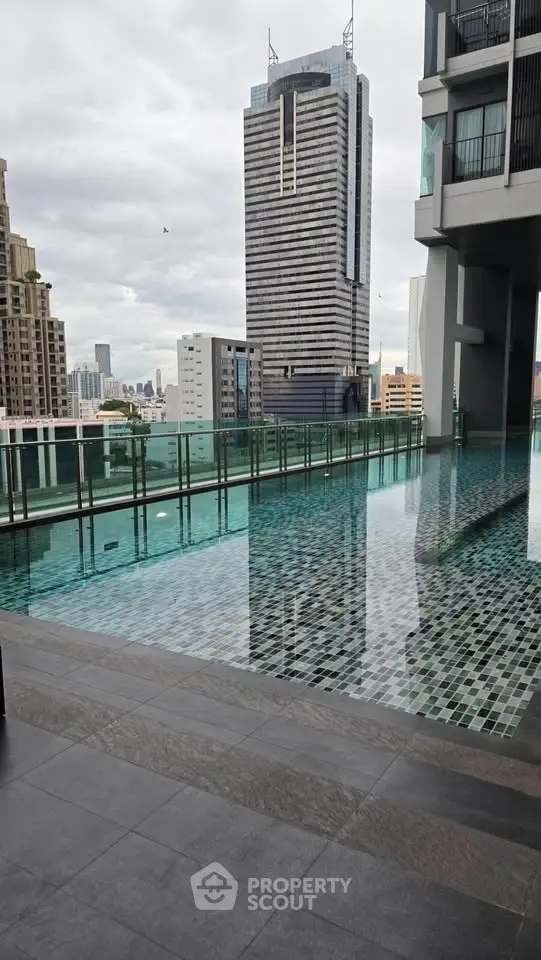 Luxurious high-rise building with stunning rooftop pool and city skyline view.