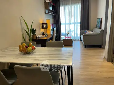 Modern living room with stylish decor and natural light, featuring a cozy seating area and elegant dining space.