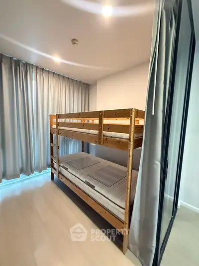 Modern bedroom with bunk beds and floor-to-ceiling curtains in a bright, minimalist design.