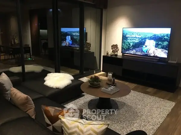 Modern living room with cozy sectional sofa and large TV, perfect for entertainment.