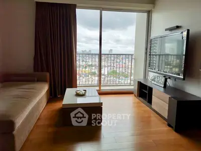 Spacious living room with city view, modern furniture, and large window for natural light.