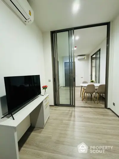 Modern living room with sliding glass doors and dining area