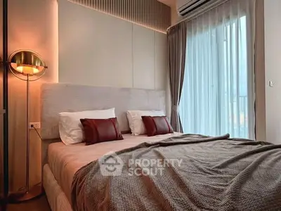 Luxurious bedroom with elegant decor and large window for natural light