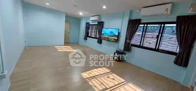 Spacious living room with large windows and air conditioning, perfect for modern living.