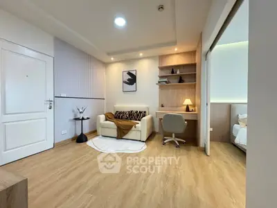 Modern living room with cozy seating and stylish decor in a contemporary apartment.