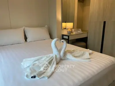 Elegant bedroom with stylish decor and cozy ambiance, featuring a neatly arranged bed and soft lighting.