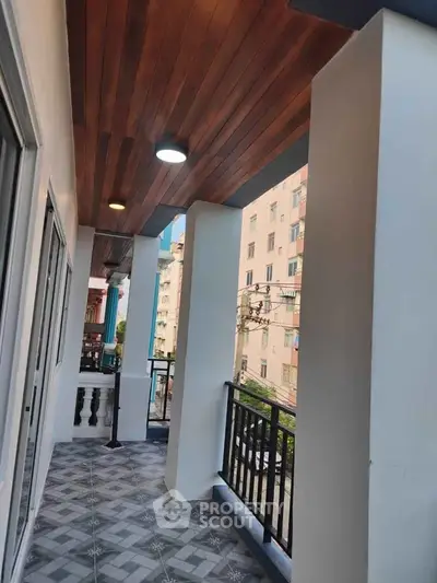 Spacious balcony with modern design and city view, perfect for relaxation and entertaining.