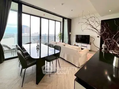 Luxurious high-rise living room with stunning city view and modern furnishings.