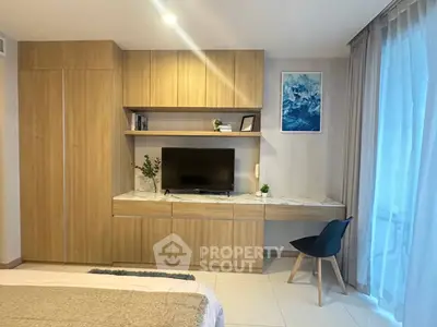 Modern bedroom with built-in wooden cabinets and large window for natural light.
